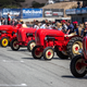 Porsche tractors in their usual red and yellow paint scheme lined up on the grid for the first race.